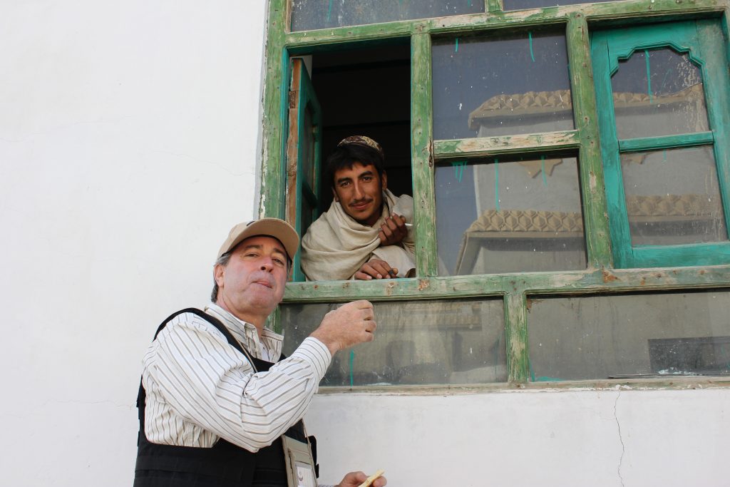 Paul drinking tea from guy at window